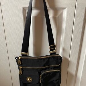 Black Messenger Bag with Adjustable Strap and Gold Accents